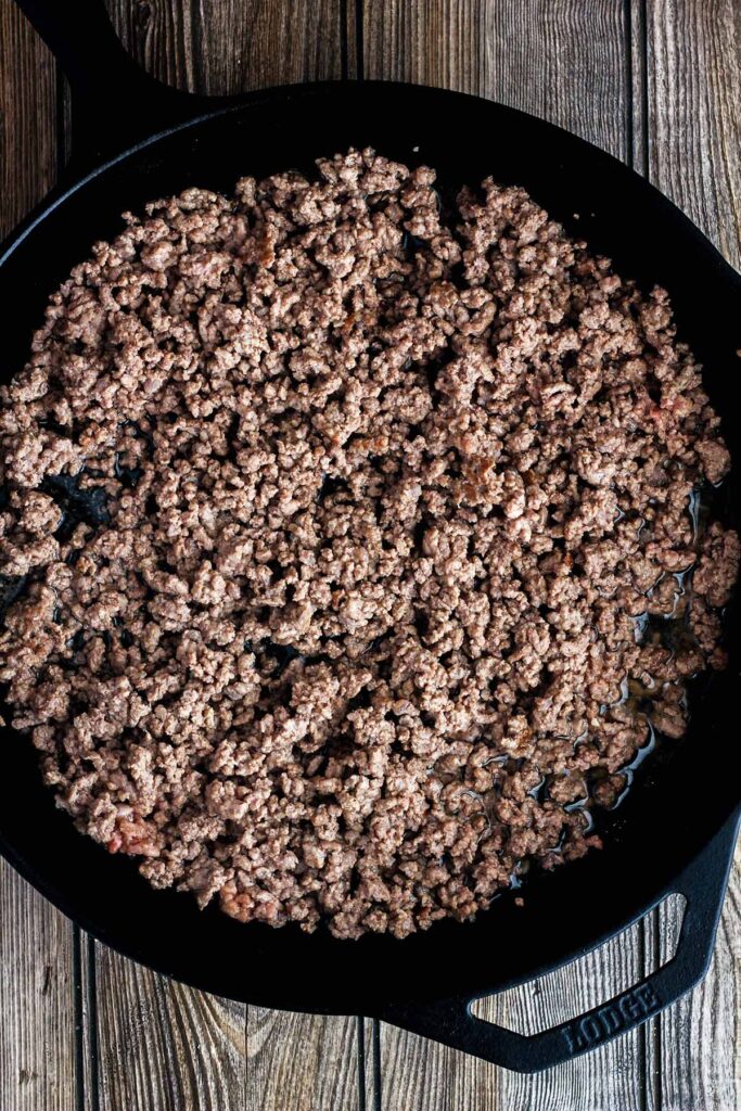 Cooked ground beef in a cast-iron skillet.