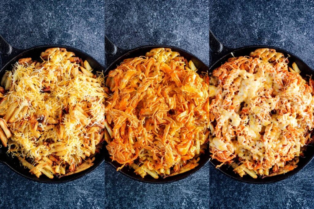 Fries in a skillet layered with cheese, then buffalo chicken, and finally more cheese.