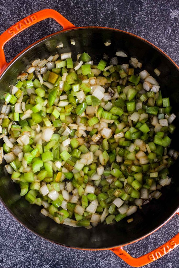 Sautéed onion, celery, and bell pepper in a Dutch oven.