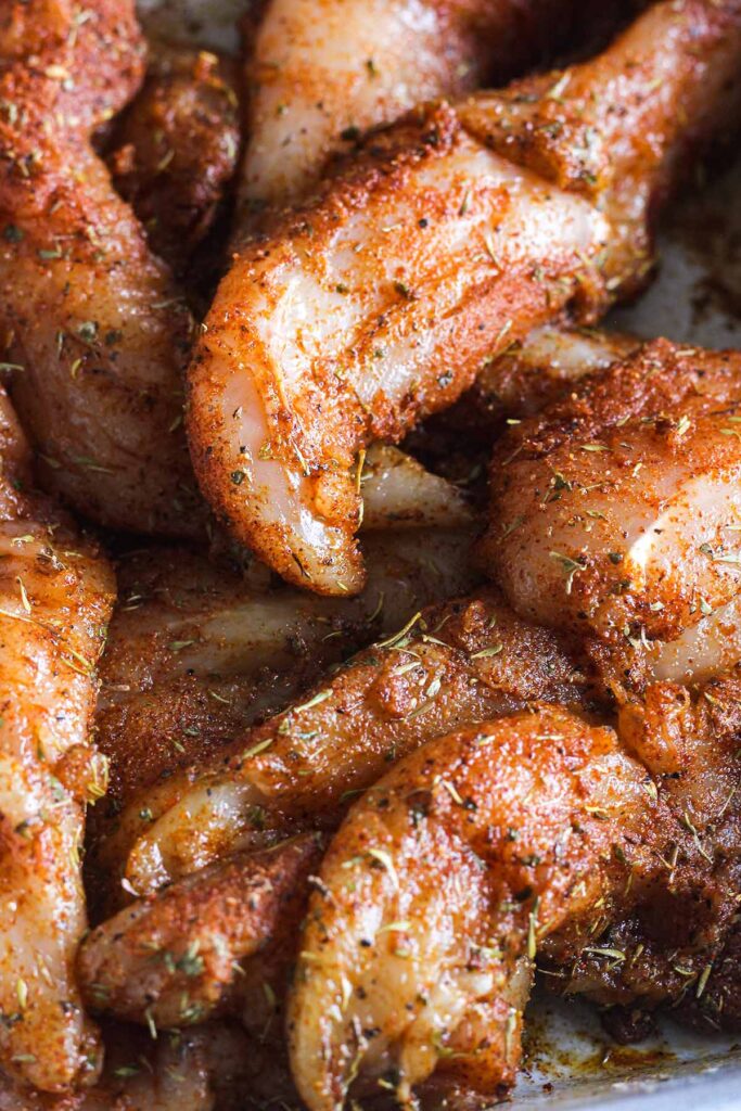 Close-up of seasoned chicken tenderloins.