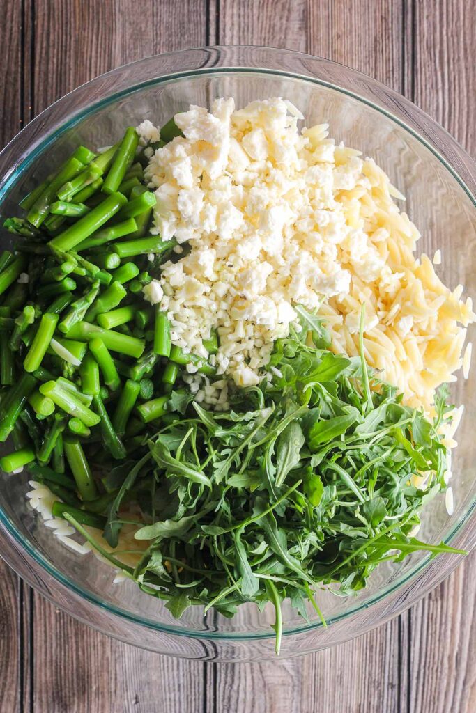 Ingredients for pasta salad in a bowl prior to mixing