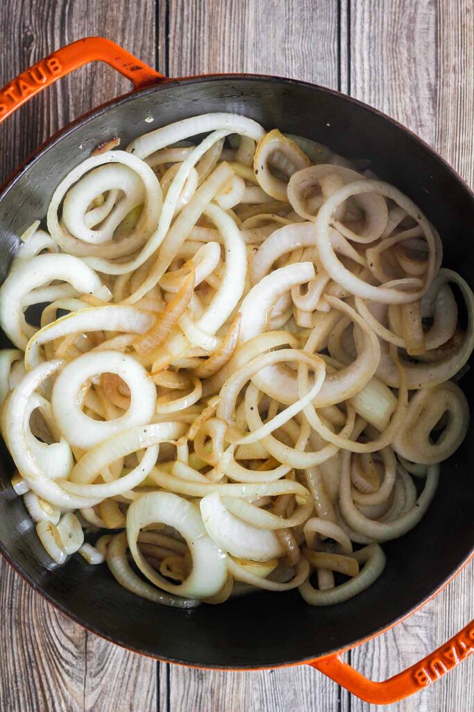 Sautéed onions in a Dutch oven.