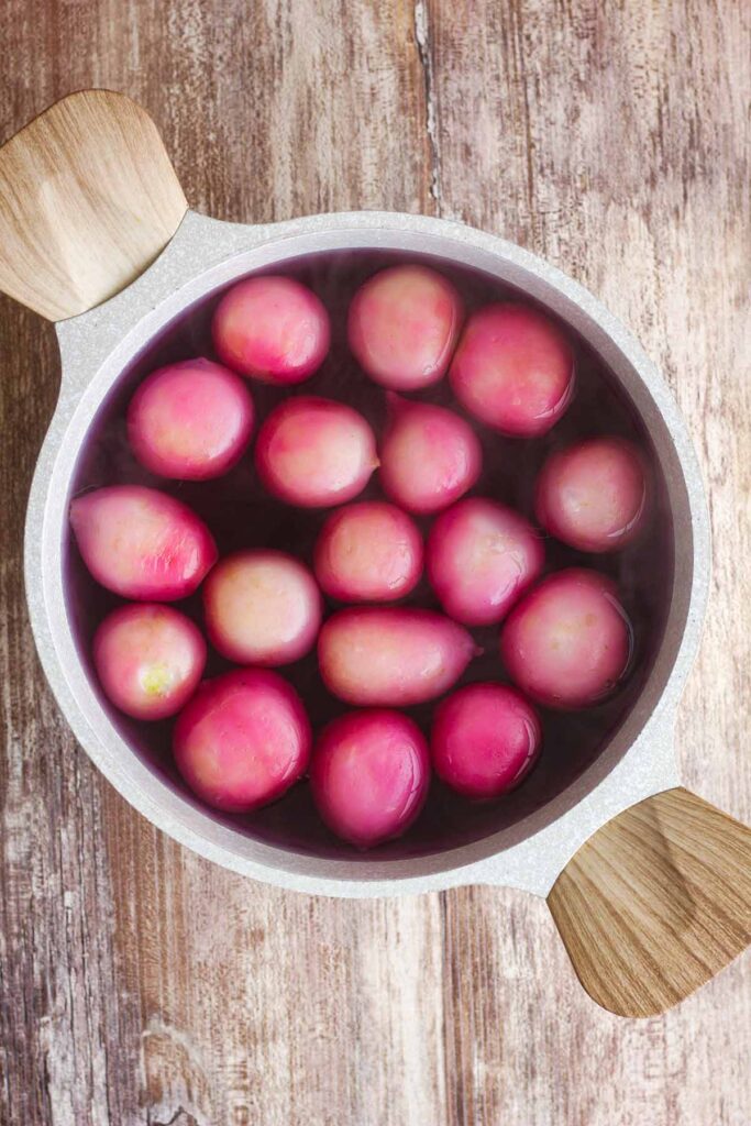 Boiled radishes in a saucepan.