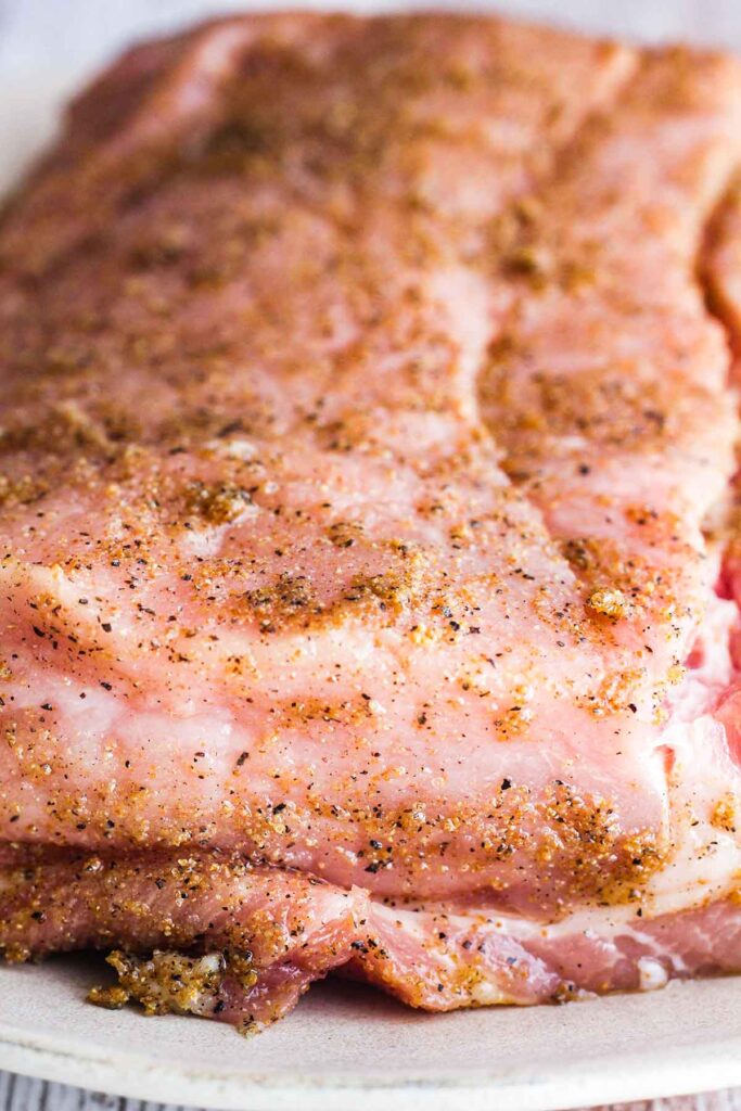 Close up of pork loin rubbed with spice mixture.