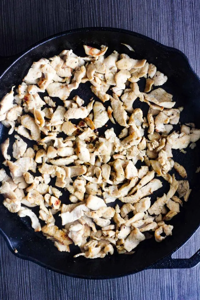 Cooked chicken in a cast-iron skillet.
