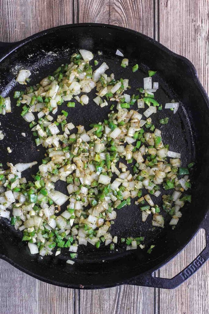 Sautéed onion and jalapenos in cast-iron skillet.