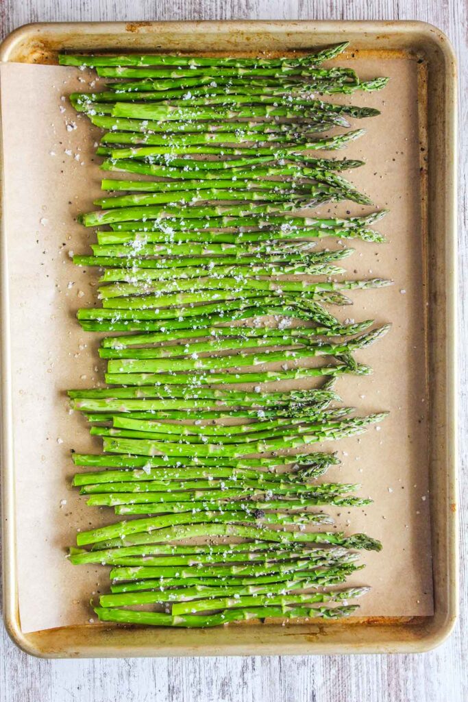 Truffle asparagus on a baking sheet prior to baking.