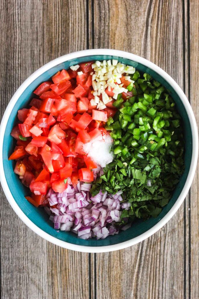 Unmixed ingredients for pico de gallo in a bowl.