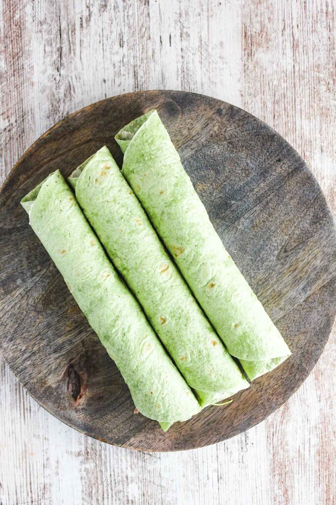 Three rolled uncut wraps on a tray.