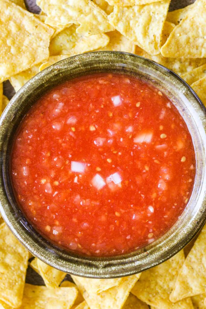 Bowl of fresh habanero salsa surrounded by chips.