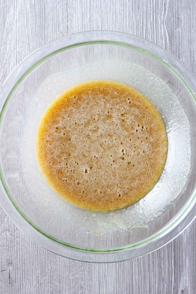 Butter and sugar mixture in a clear bowl.