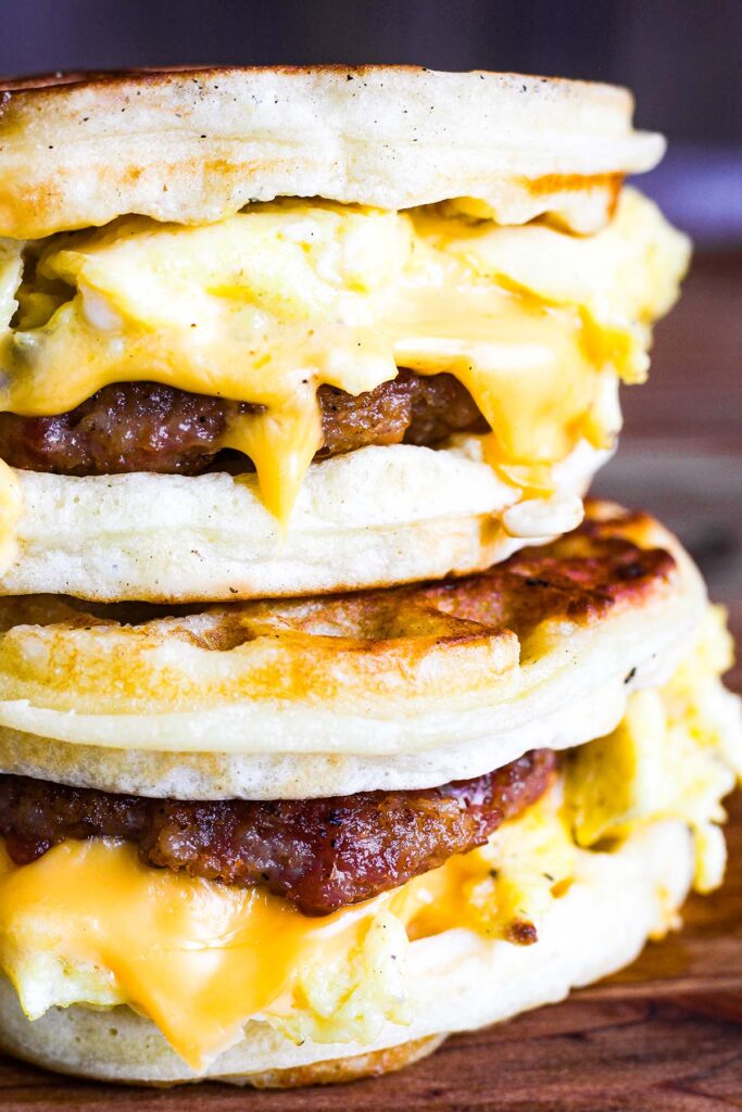 Close up of sausage, egg, and cheese waffle sandwiches.