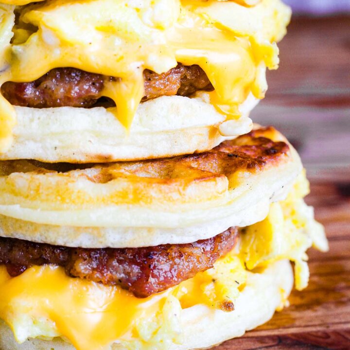 Two waffle breakfast sandwiches stacked.